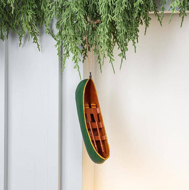 Canoe Ornament: This charming metal canoe ornament in green and red floats through your holiday decor, bringing a splash of lakeside cheer to your Christmas tree!