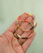 Hand holding Colorful beaded Gold hoop earrings