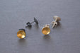 Close-up of Silver & Gold Pool Studs featuring a mix of sterling silver and 23k gold leaf, because who said your ears can’t have a little bling while keeping it classy?