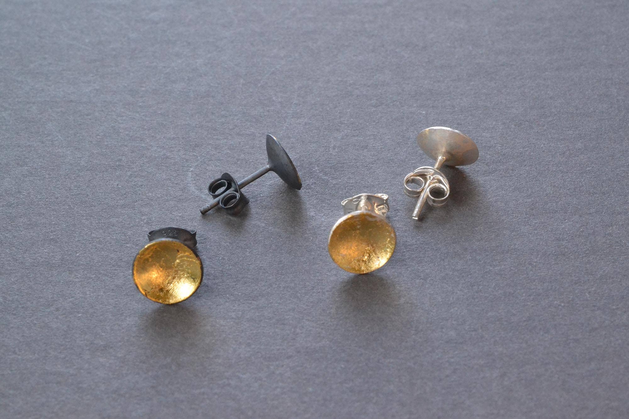 Close-up of Silver & Gold Pool Studs featuring a mix of sterling silver and 23k gold leaf, because who said your ears can’t have a little bling while keeping it classy?