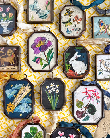 Vintage-style art locket ornaments.