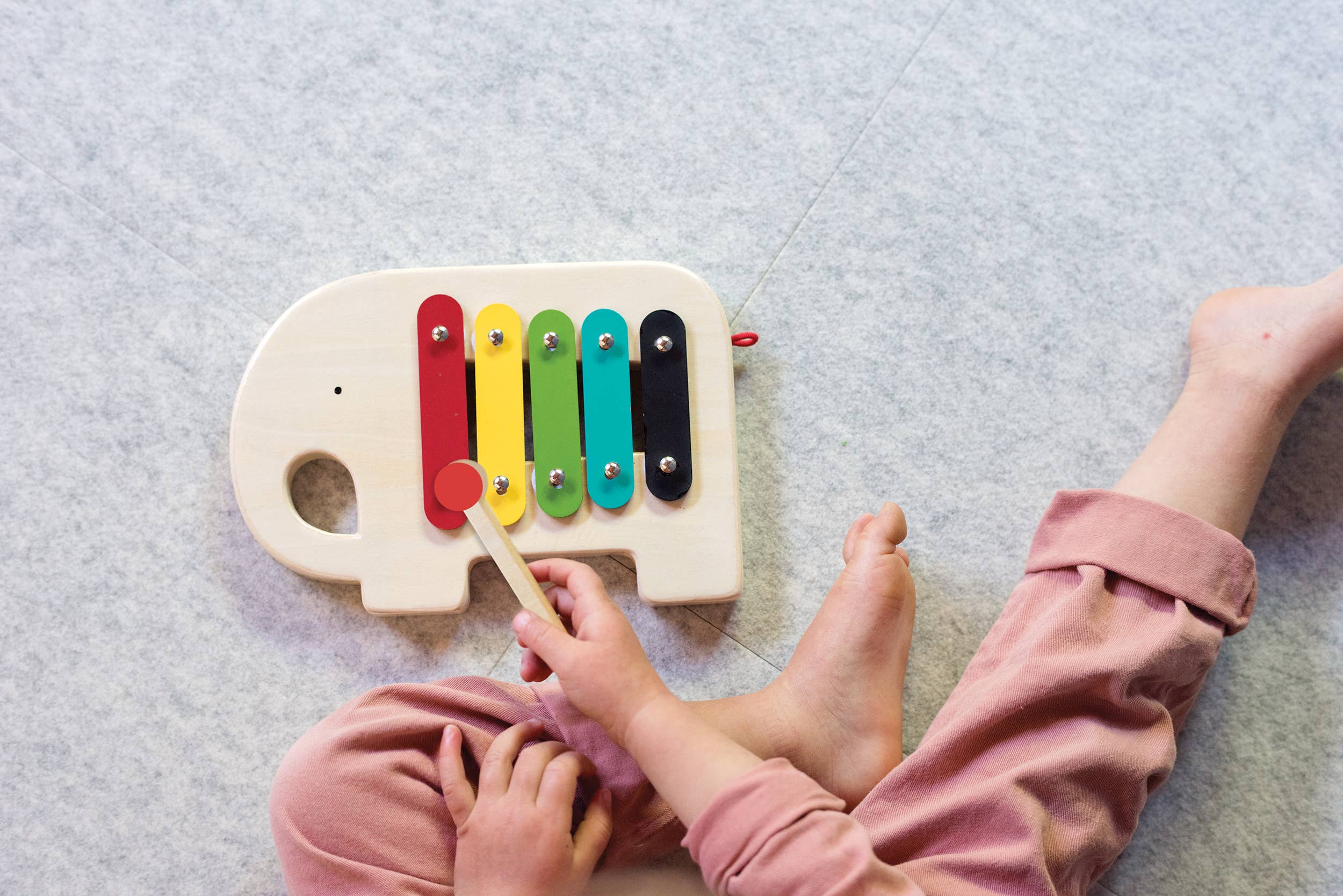 child playing with Wooden Elephant Xylophone