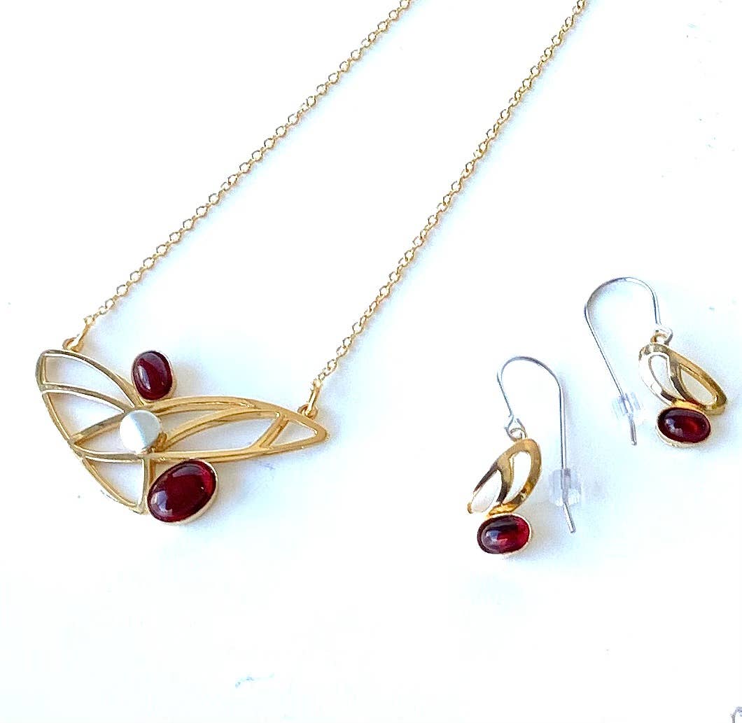 steel jewelry with red gemstones