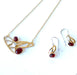 steel jewelry with red gemstones