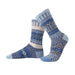 Azure Crew Socks by Solmate Socks feature a vibrant design with various shades of blue, including baby blue and marine, showcasing a unique geometric pattern crafted from sustainable materials.