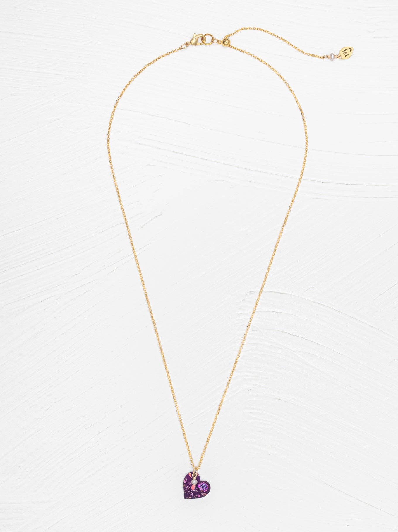 Budding Heart Pendant on a stylish neck, turning heads with its subtle gold charm and adorable simplicity, because why scream when you can softly convey love?