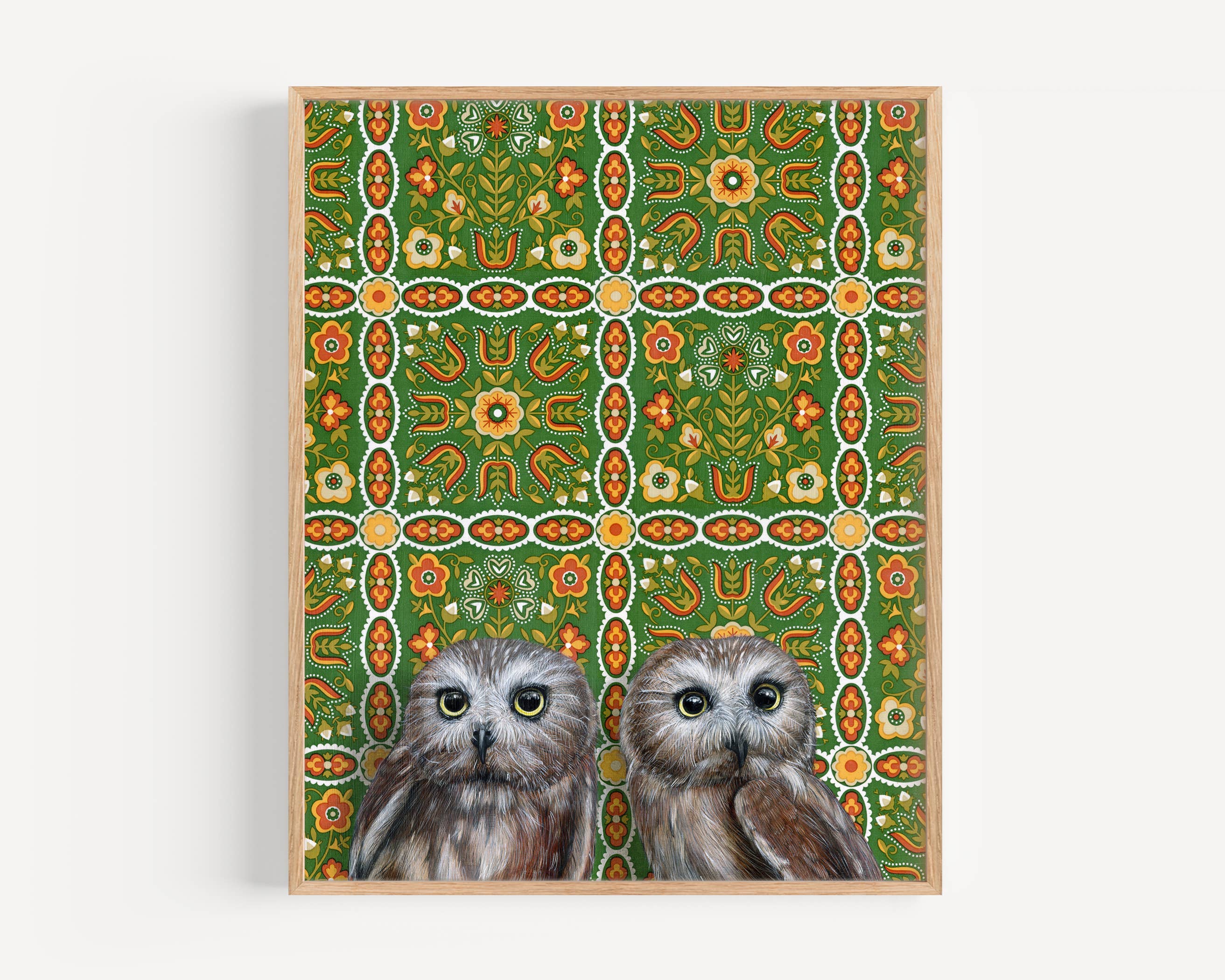 Framed art print of two owls on a patterned background.