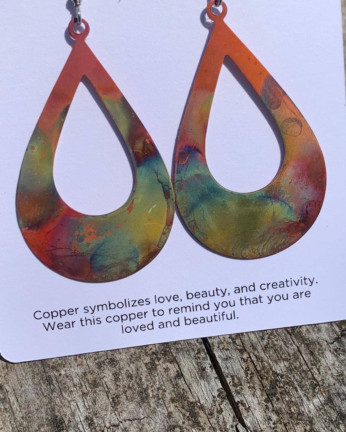 Close-up of the Boho Large Open Teardrop Fire Painted Copper Earrings, highlighting the intricate craftsmanship and fiery designs.