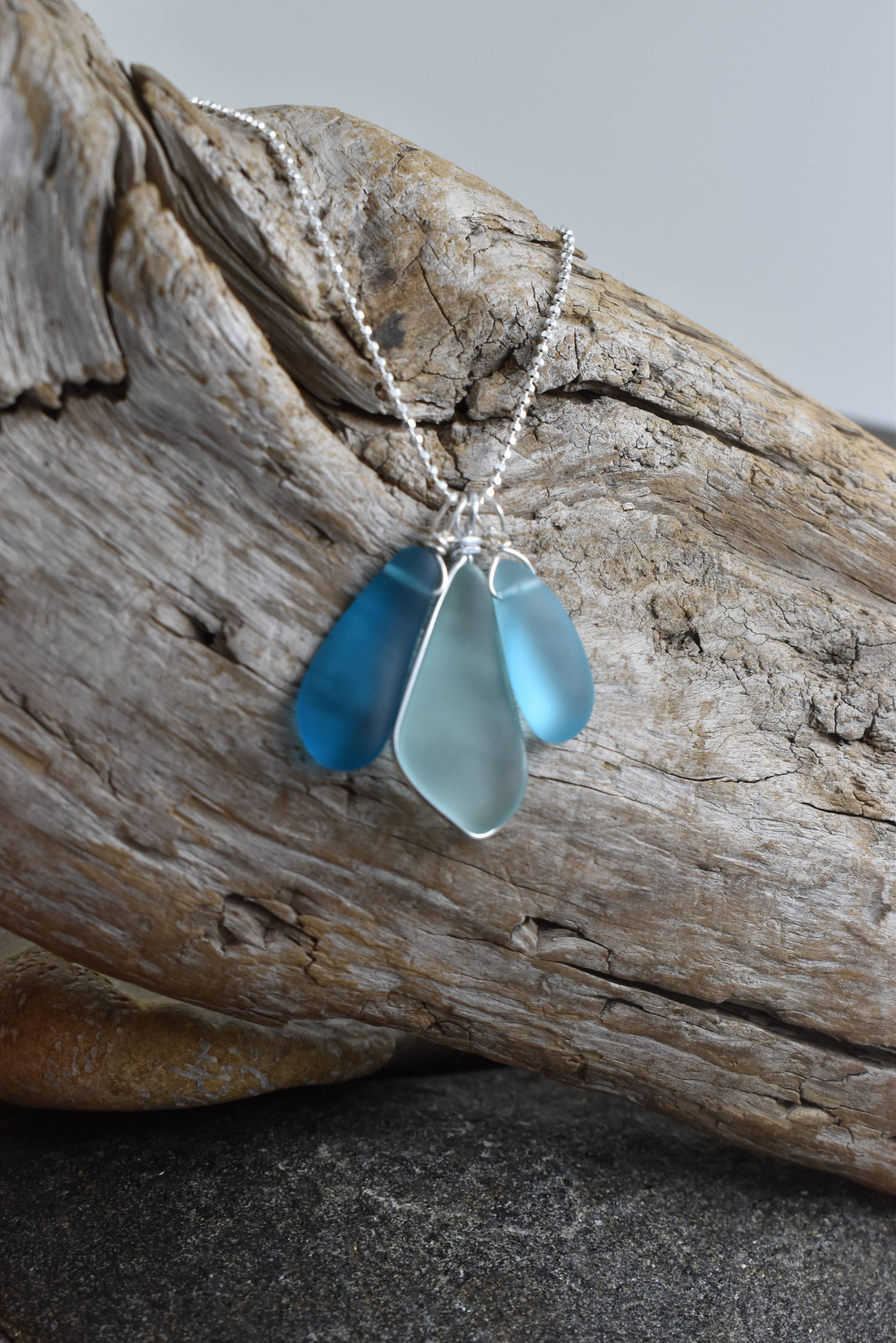 Blue Eco Glass Trio Sterling Silver Necklace by Whitelotus Design featuring three stunning eco-friendly recycled glass drops in layered ocean blue shades.