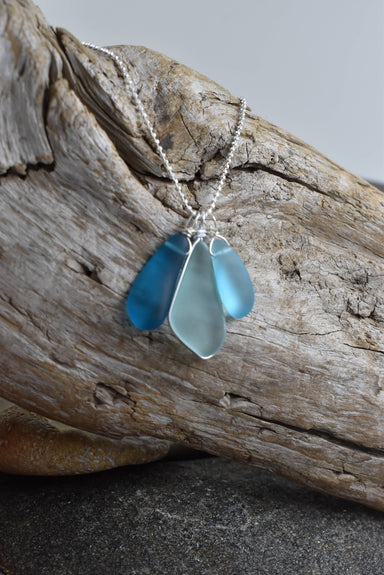 Blue Eco Glass Trio Sterling Silver Necklace by Whitelotus Design featuring three stunning eco-friendly recycled glass drops in layered ocean blue shades.