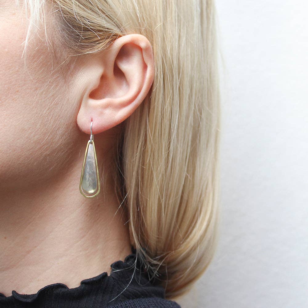 Teardrop with Teardrop Ring Wire Earrings by Marjorie Baer worn on a model's ear, highlighting the contemporary two-tone design and graceful movement of the earrings.