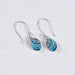 Stylish close-up of Crystal & Silver Oval Earrings highlighting their refined elongated shape.