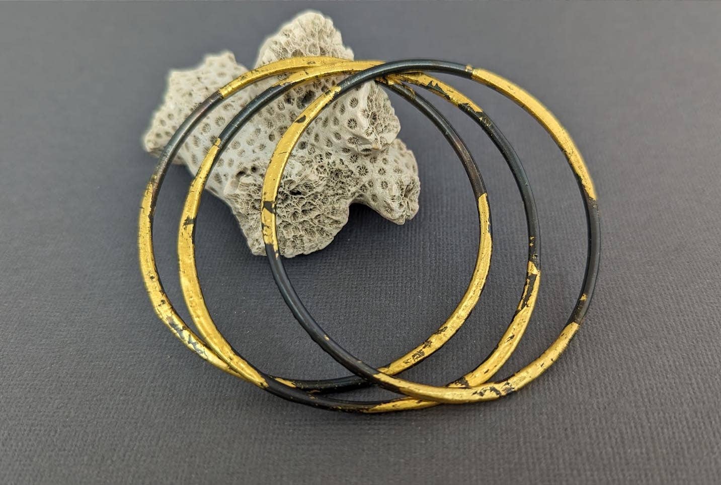 Stylish Forged Steel and Gold Bangle: 10 gauge steel, forged for that perfect triangular shape, and then given a luxurious 23k gold hug—because your wrist deserves a lavish hug too, but maybe not a swim in the pool!