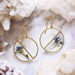 Forget Me Not Pressed Flower Earrings featuring real pressed flowers and resin in a stylish round shape with brass frames and gold plated ear wires.
