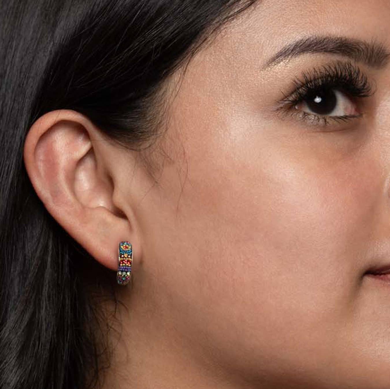 Styling idea with the Petite Crystal & Silver Huggie Earrings, highlighting their snug fit and colorful design, ideal for elevating both casual and formal outfits.