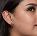 Styling idea with the Petite Crystal & Silver Huggie Earrings, highlighting their snug fit and colorful design, ideal for elevating both casual and formal outfits.
