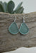 Close-up of Eco Glass Bezel Drop Silver Earrings, featuring lightweight frosted glass in seafoam hue.