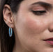 Stylish model wearing Mosaico Jewels extra large hoop earrings with crystals and silver, demonstrating versatility in fashion styles.