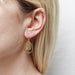 Model wearing Curved Teardrop and Teardrop Rings Wire Earrings, highlighting their fun and cute design with an eye-catching look.