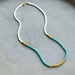 Lithe No. 2 Beaded Necklace by The Silver Wren showcasing a beautiful combination of turquoise and white seed beads accented with gold, designed to complement a bright and joyful style.