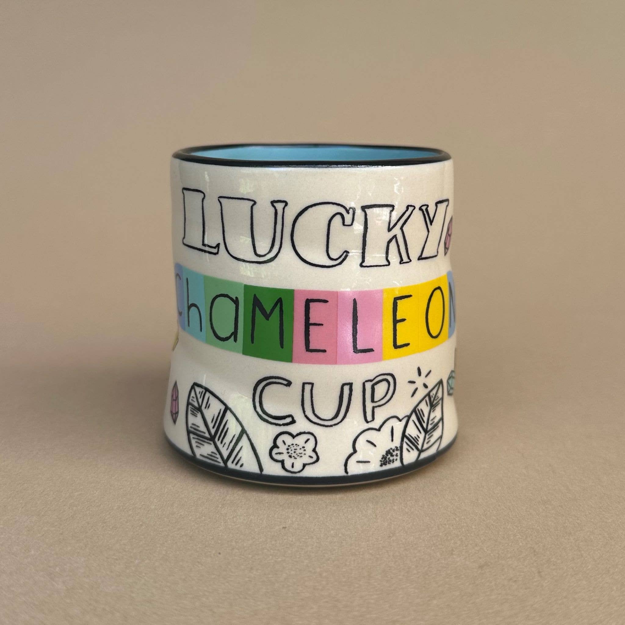 Lucky Chameleon Cup - Medium by The Bowl Maker features a playful design with colorful lettering and decorative elements. Perfect for kids and adults alike.