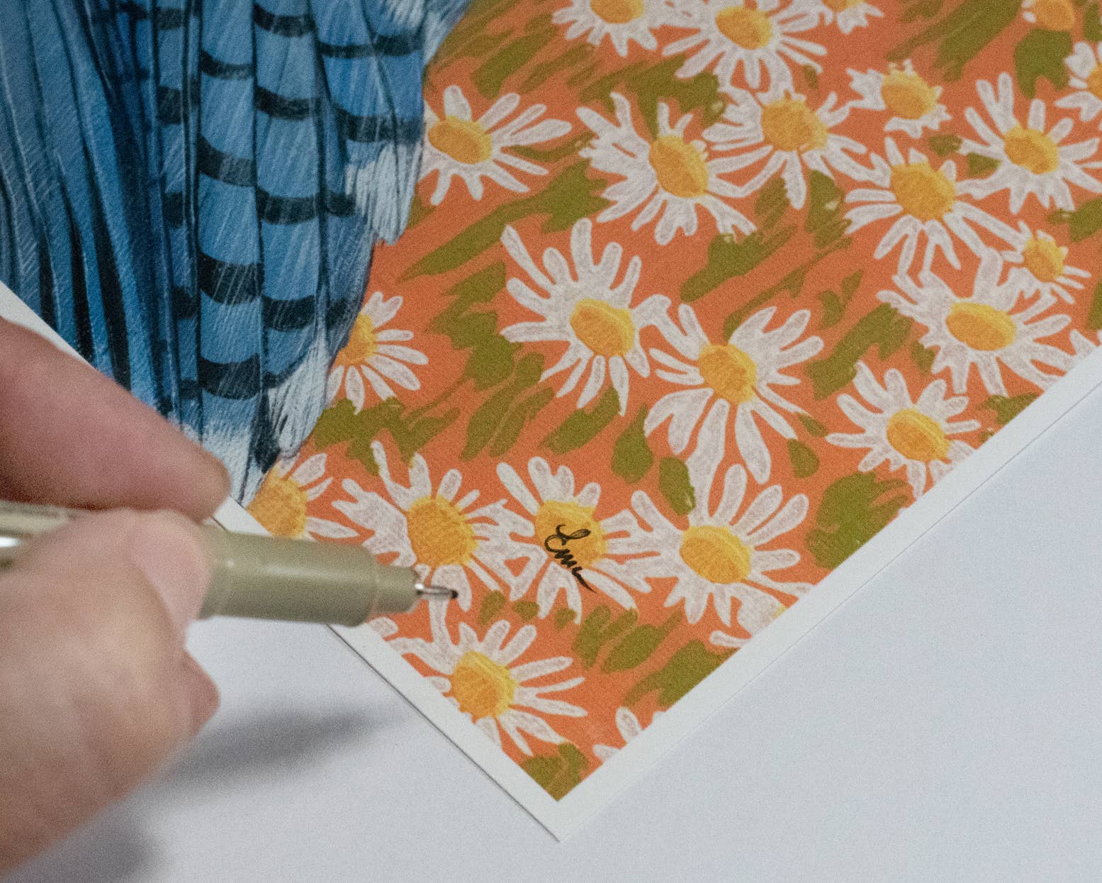 Close-up view of the Bluejay fine art print by Emily Uchytil, showcasing the artist's signature and floral details on archival matte paper. Perfect gift for bird lovers.
