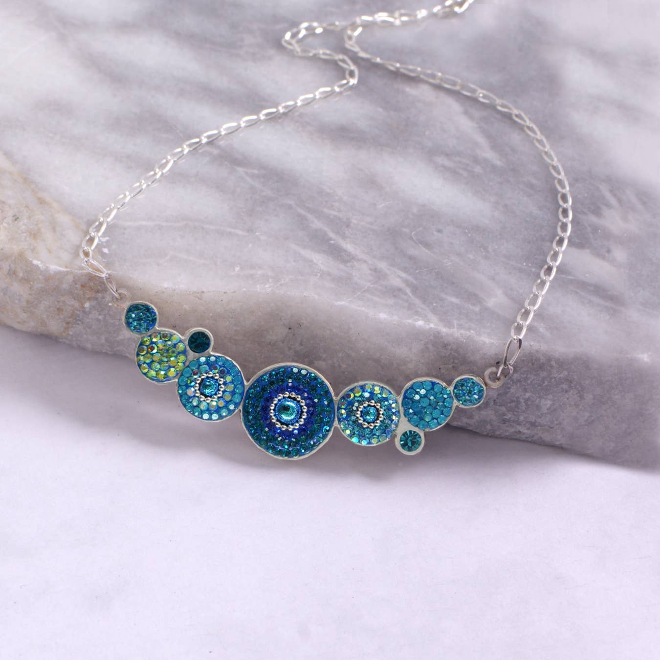Close-up view of the Bold Geometric Round Necklace In Crystal & Silver, highlighting the expertly crafted geometric shape and premium crystal details.