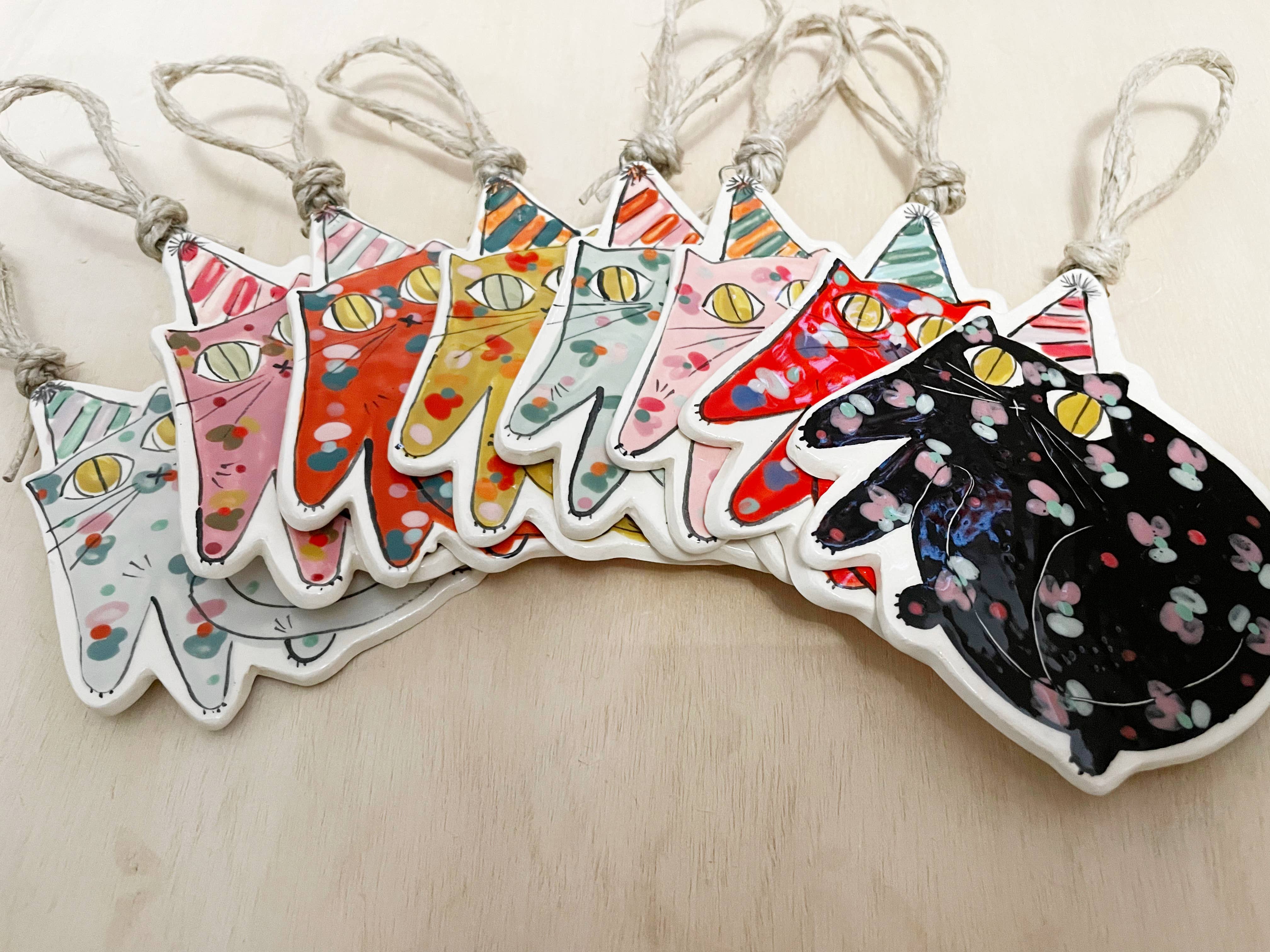 Party Cat Ornament with Colorful Party Hat: Black hanging decor featuring a festive cat design, perfect for year-round celebrations.