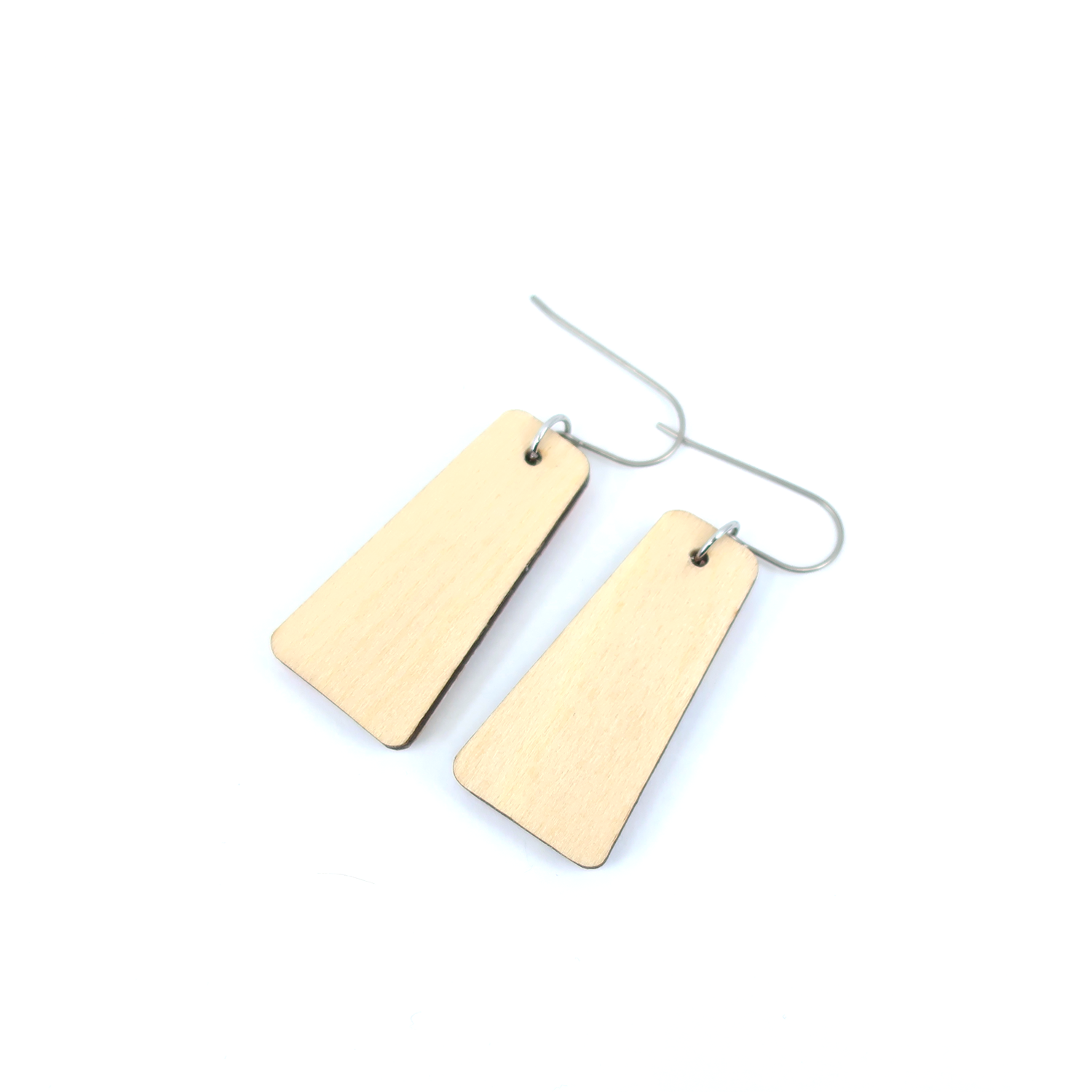 Female model wearing light blue and navy mid century modern marble dangle earrings showcasing their elegant design.