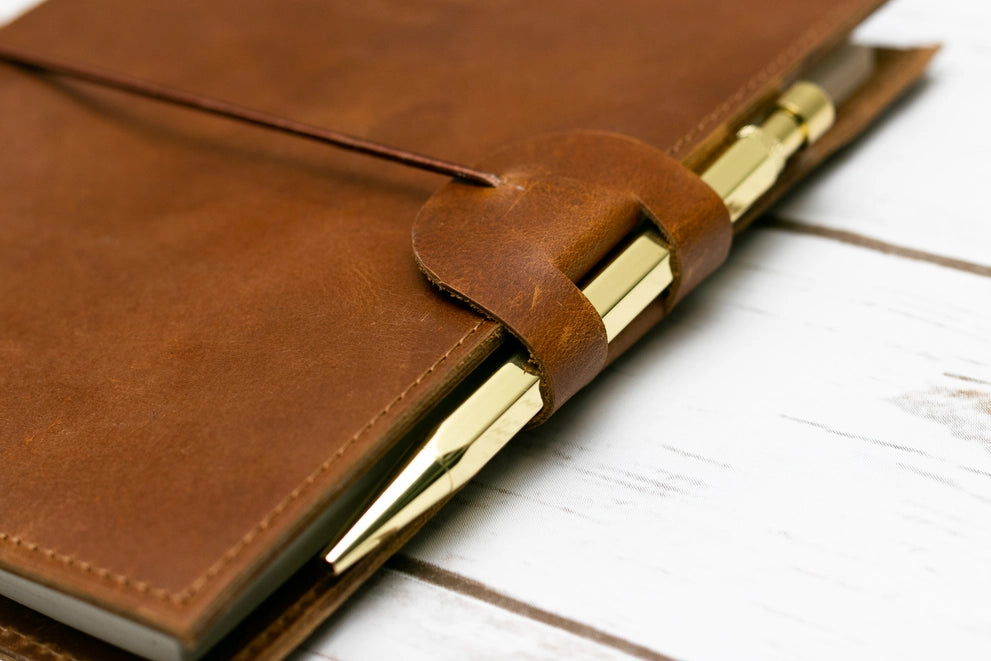 brown leather journal with pen holder