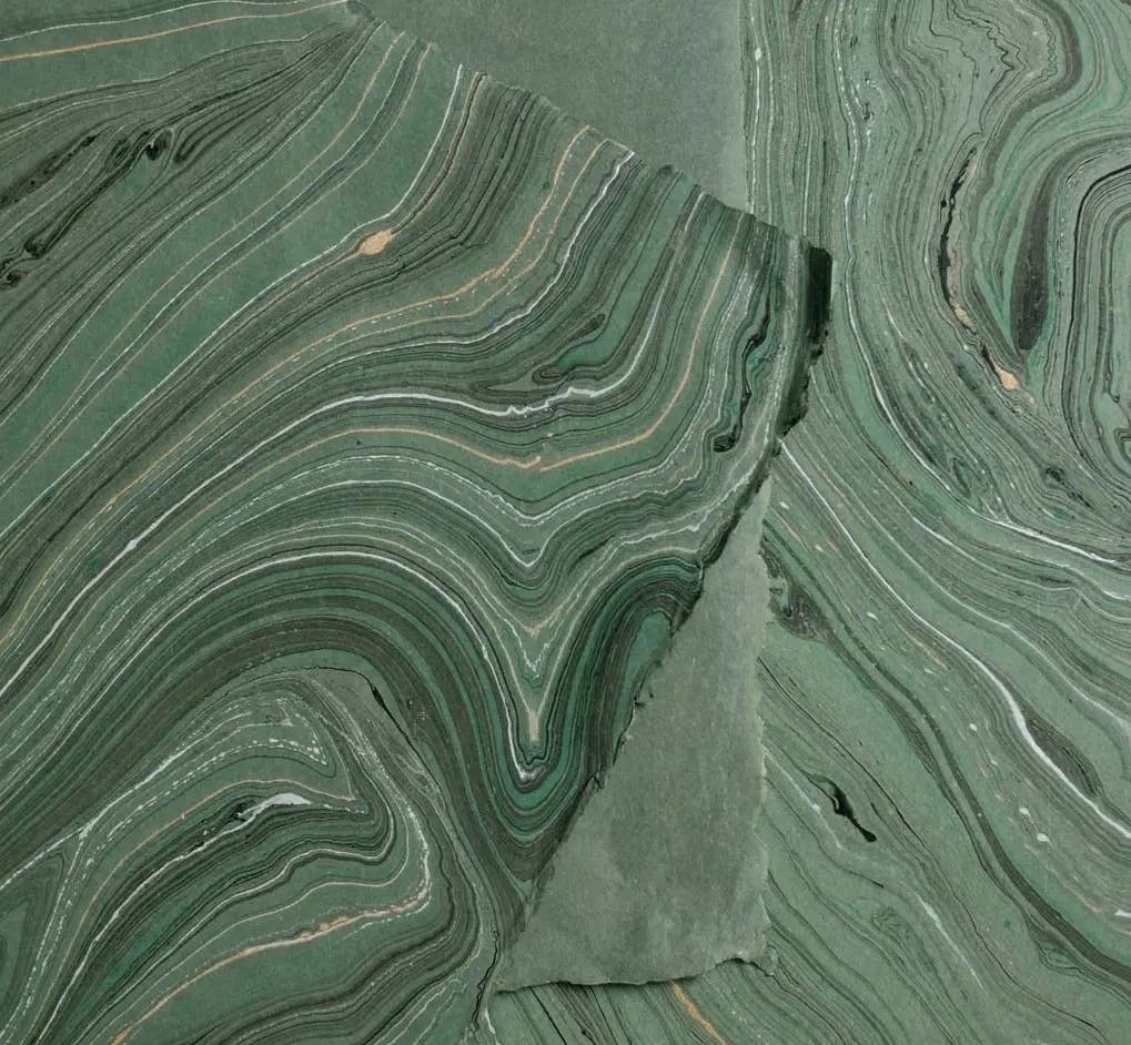 Vibrant hand-marbled paper in green and earthy tones, highlighting the beauty of craftsmanship for The Casual Bookbinder's Softcover Notebook.