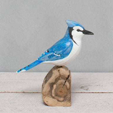 Handcrafted Blue Jay wooden bird by Aviologie, showcasing detailed carving and vibrant colors, standing on a natural wooden base, 8.5 inches high.