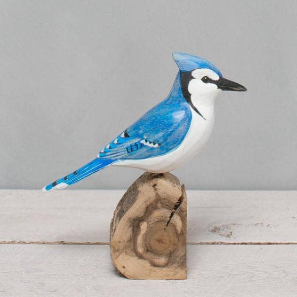 Handcrafted Blue Jay wooden bird by Aviologie, showcasing detailed carving and vibrant colors, standing on a natural wooden base, 8.5 inches high.