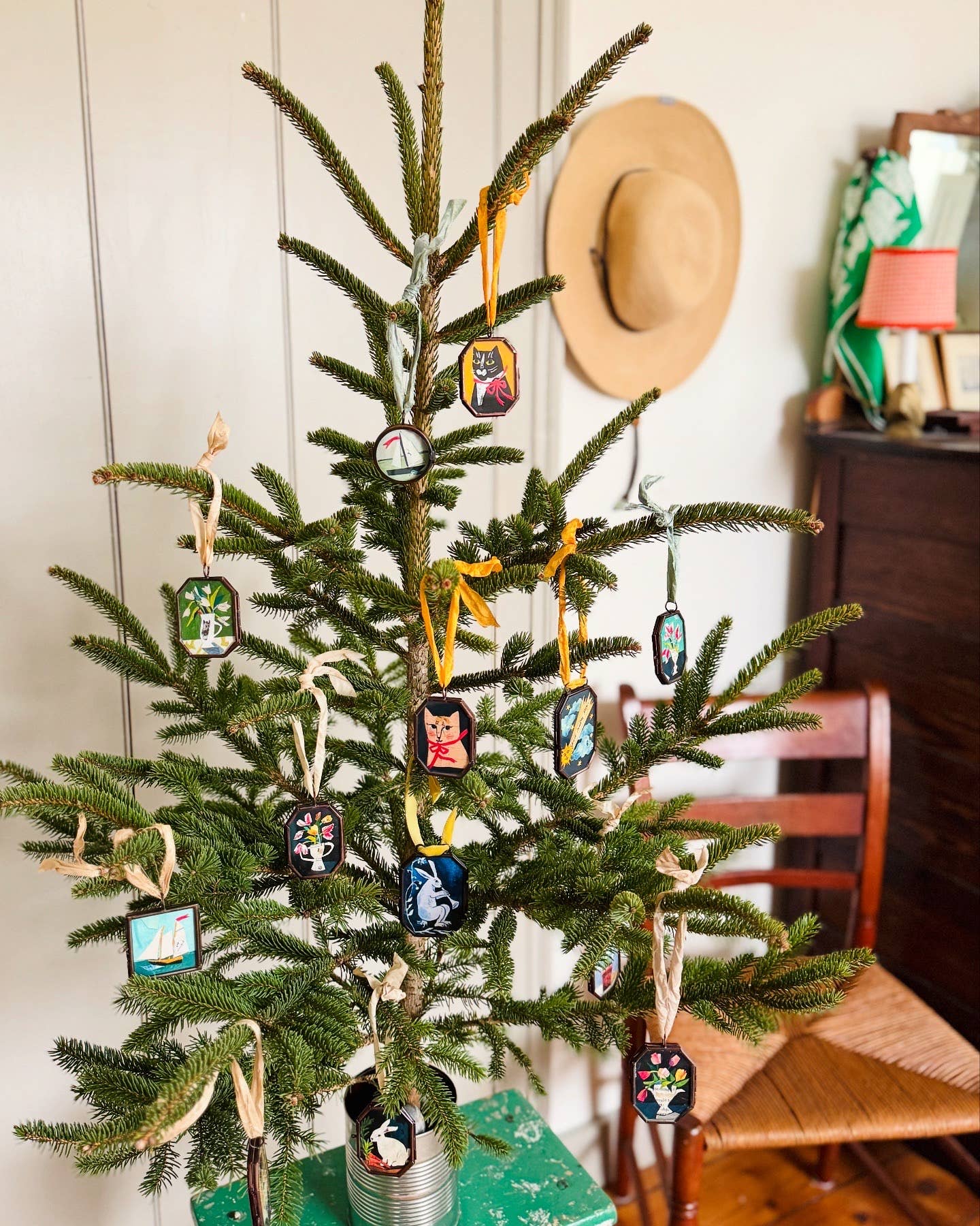 Vintage-style art locket ornament hung on Christmas tree