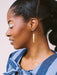 Close-up of a model wearing Skinny Dip Earrings, highlighting the earrings' vibrant colors and delicate design, created by Twenty Two West.
