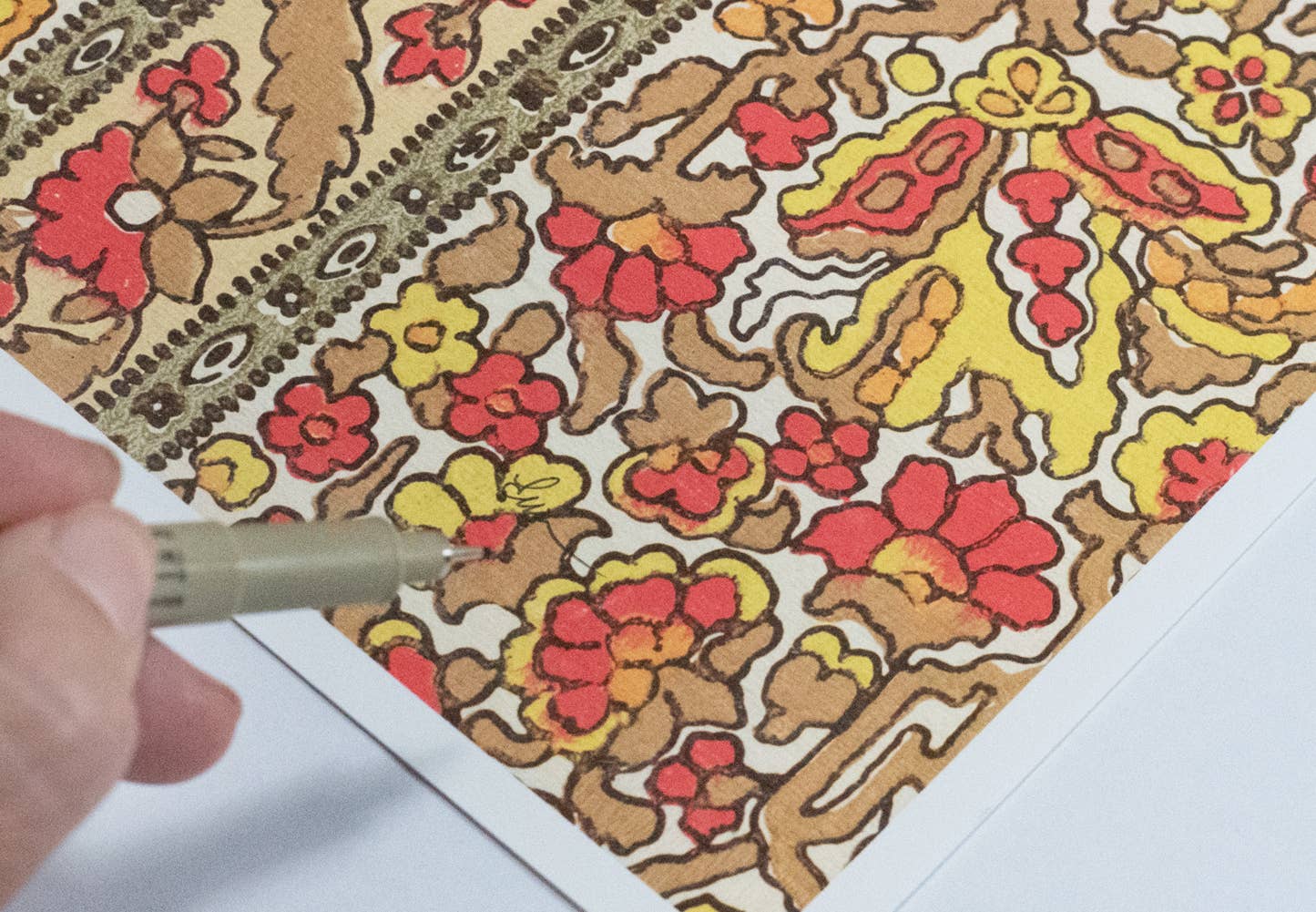 Framed art print of a dragonfly over a patterned floral background.