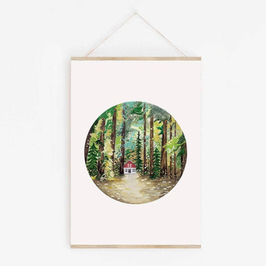 Framed artwork of a forest scene with a small house