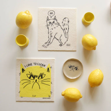 Cat-themed kitchen towels with lemons and a small bowl 