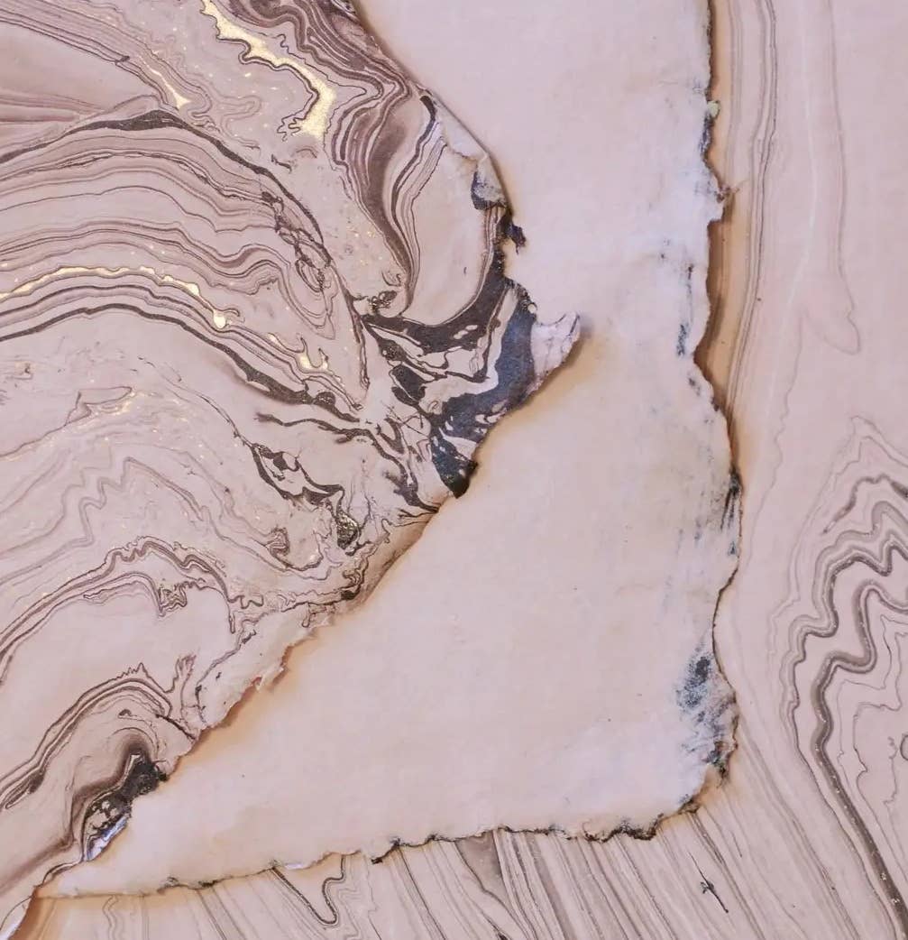 Elegant hand marbled paper in soft beige tones, designed for the Softcover Notebook by The Casual Bookbinder, highlighting craftsmanship.