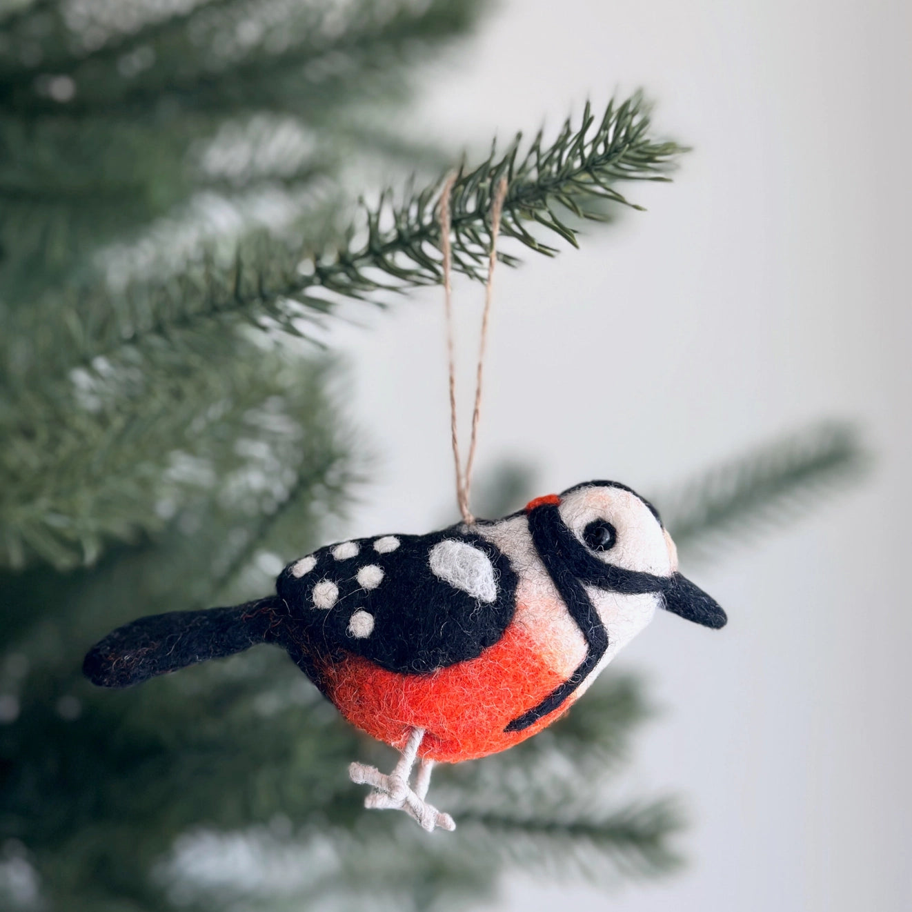 Cheerful Felt Bird Ornaments hanging on a Christmas tree, adding a whimsical touch to holiday decorations.