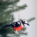 Cheerful Felt Bird Ornaments hanging on a Christmas tree, adding a whimsical touch to holiday decorations.