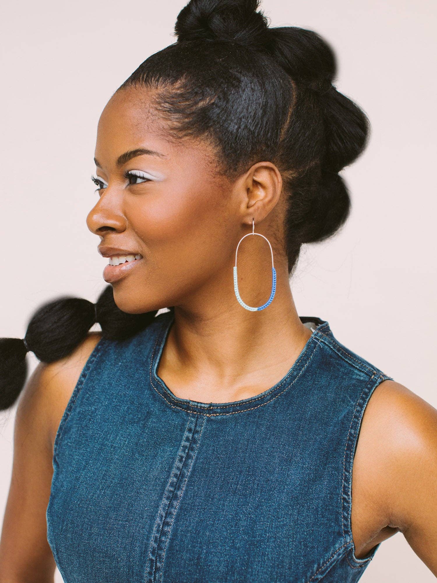 Close-up profile of a model wearing the On the Move Macramé Earrings by Twenty Two West, accentuating the earring's design.