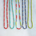 Colorful Lettie Seed Bead Necklaces by The Silver Wren, featuring vibrant seed beads in combinations of red, turquoise, navy, and green, accented with tiny gold beads, perfect for layering or wearing solo.