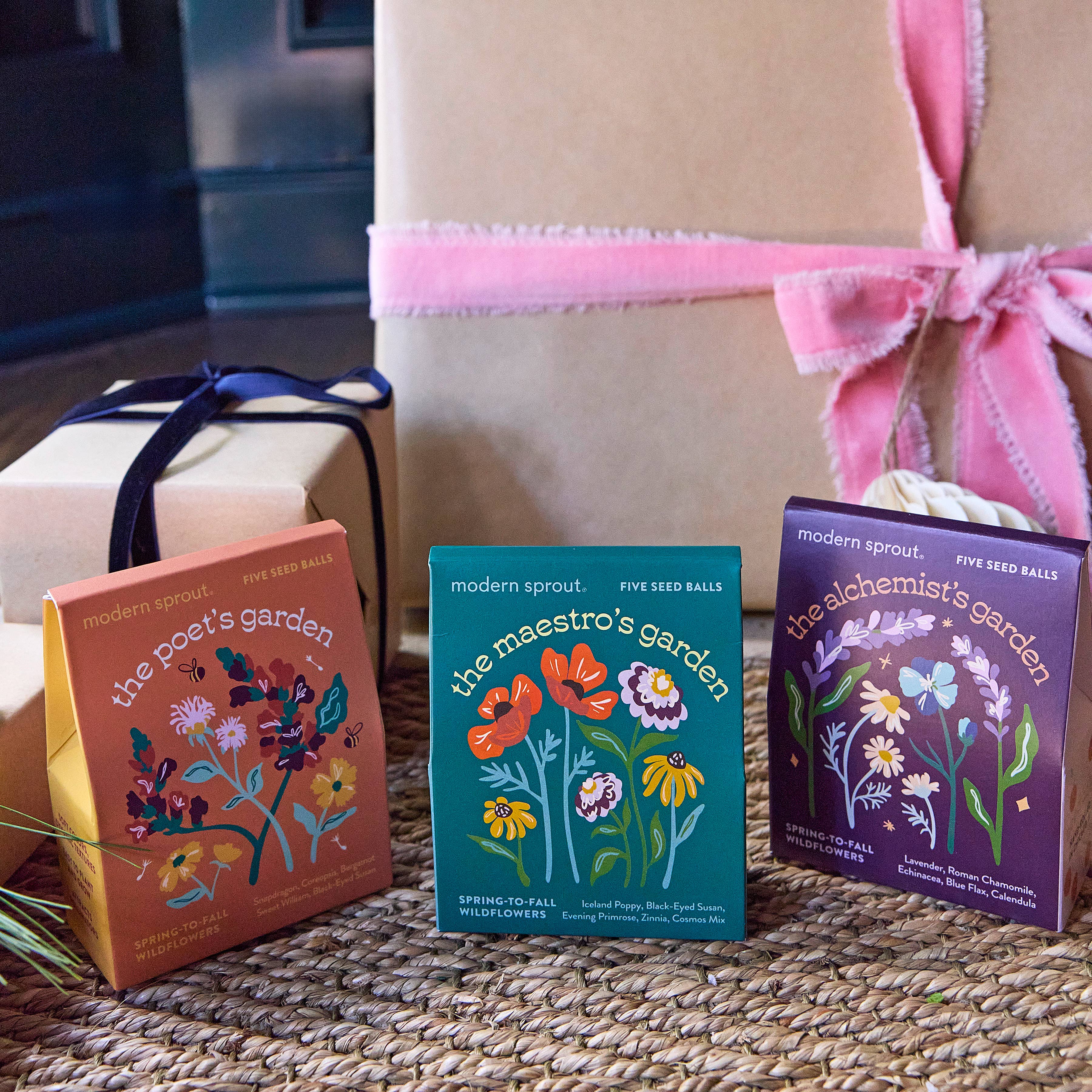 Bespoke Blooms by Modern Sprout featuring three seed ball collections—The Poet's Garden, The Maestro's Garden, and The Alchemist's Garden—arranged as a colorful display with a gift box.