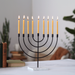 Black menorah with lit candles