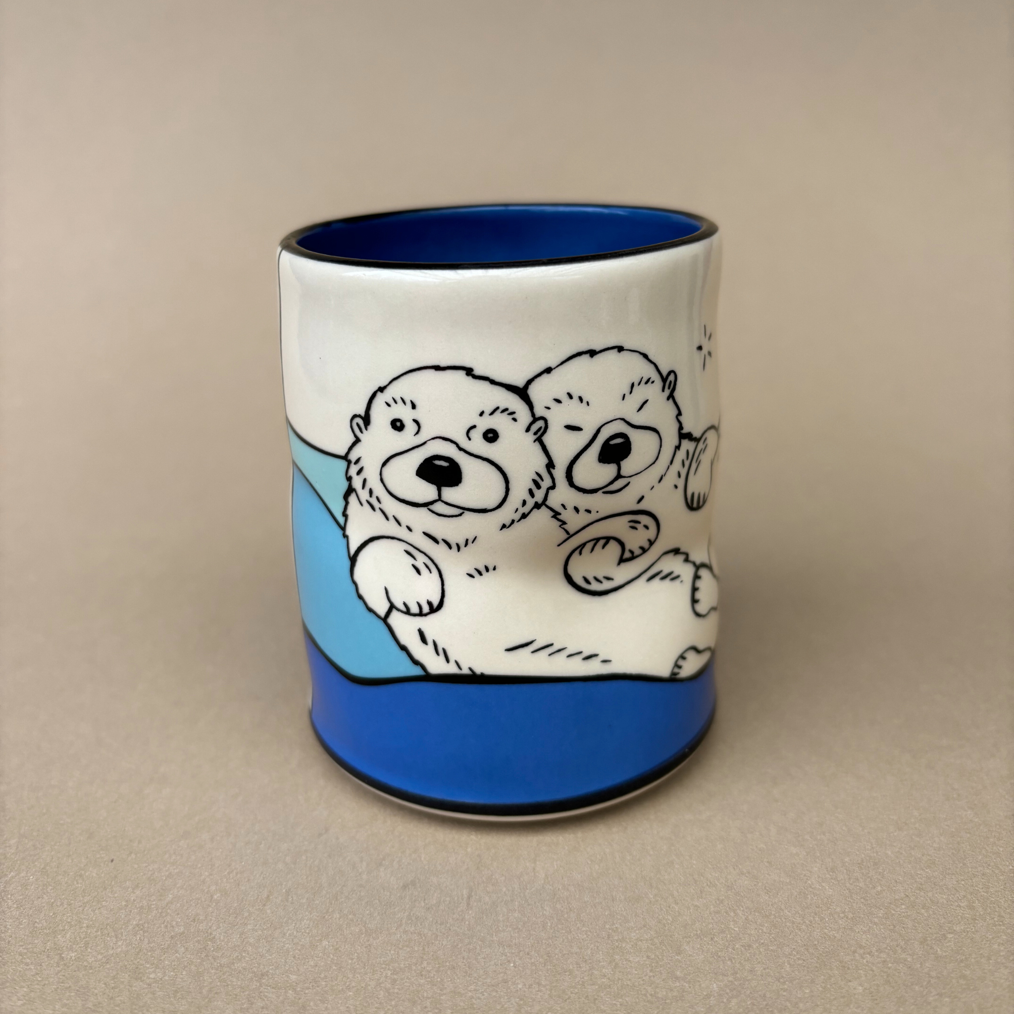Lucky Otter Cup featuring two otters in a relaxed pose, perfect for cozy moments, designed by The Bowl Maker.