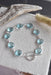 Artisan-crafted sterling silver sky blue topaz bracelet with bezel-set gemstones and secure toggle clasp, designed by Whitelotus Design.