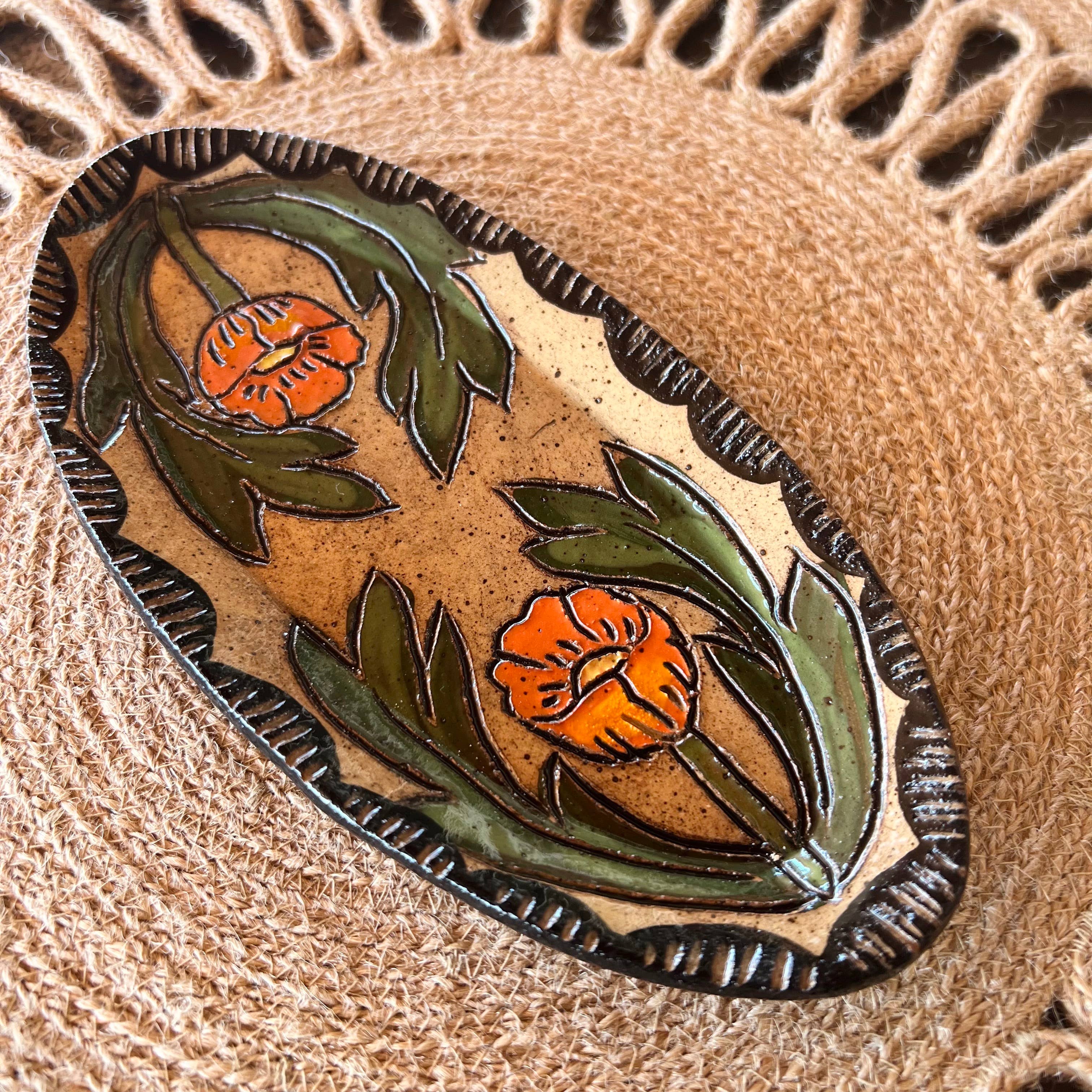 Handmade Globe Mallow Sgraffito Trinket Dish by Tough Kitty Designs, featuring a unique oval shape with vibrant globe mallow flower designs on buff clay, finished with a glossy touch.