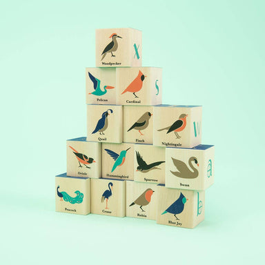 A playful and whimsical view of Uncle Goose Bird Blocks showcasing debossed letters, crafted from sustainable materials with a dash of 1920s fashion flair.