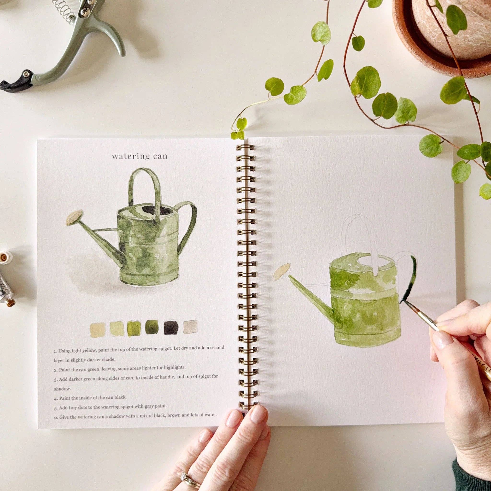 A joyful scene of children and adults painting together from the Garden Watercolor Workbook, highlighting the fun and creativity of watercoloring.